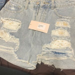 Light colored shorts with rips. new!